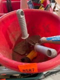 Red bucket with lawn tools