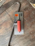 Notched trowel and crow bar