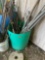 Green barrel with misc poles *BUYER IS RESPONSIBLE FOR LOADING*