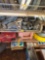 Items on second shelf are casters, tire tube, and miscellaneous lawnmower tires