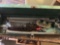 Metal pieces and pipe cutter in green toolbox