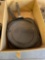 Box of skillets and a metal plate