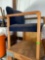 Wood frame chair with blue seat cushions