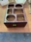 Wooden box with holes cut out of top