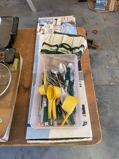 Silverware, measuring cups, mini tool bag and a paint stick