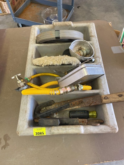 Gray plastic caddy with knife, wrench, castor, spoon and more