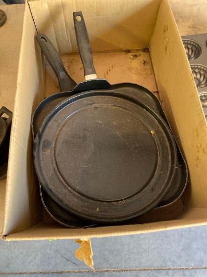 Box of skillets and a metal plate