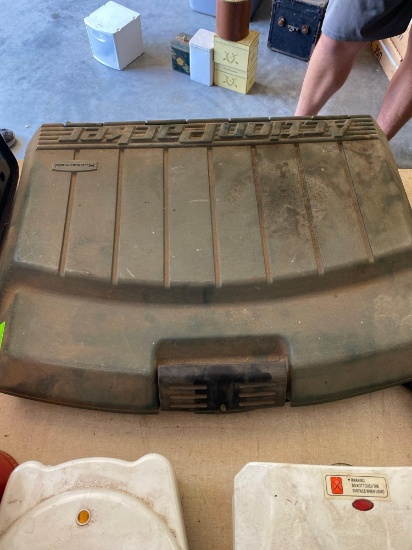 Action packer case with barbecue grill items and a vintage cutting board with mushroom pattern