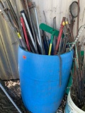 Blue barrel with misc poles, mops, and more *BUYER IS RESPONSIBLE FOR LOADING*