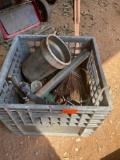 Milk crate with broom head, rope, metal container, and other miscellaneous items