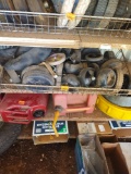 Items on second shelf are casters, tire tube, and miscellaneous lawnmower tires