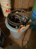 Bucket with various hose, long socket, metal poles, and more
