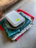 Table cloths, pie pan and tupperware ice cream container