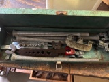 Metal pieces and pipe cutter in green toolbox