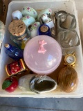 Several glass containers with corks, plastic pink bowl with lid, ceramic baby shoe, ceramic egg,