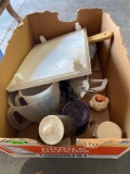 Plastic white tree, metal TV trays, large measuring cups Tupperware, Cheese slicer, utensils, and