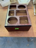 Wooden box with holes cut out of top