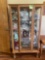 Vintage curio cabinet with glass shelves, and key to lock. Contents in cabinet are not included.