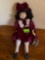 Porcelain doll and maroon dress with present