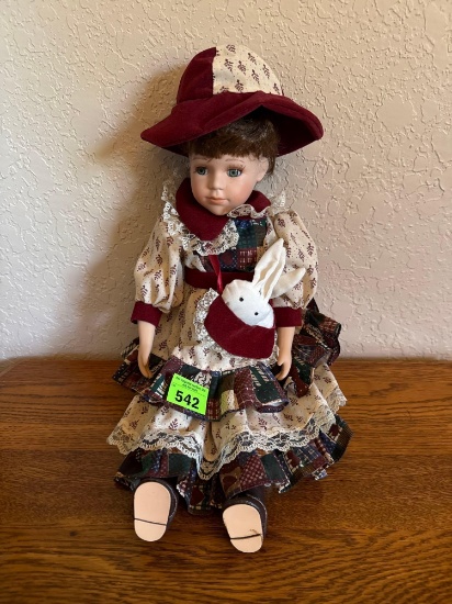 Porcelain doll with hat and rabbit and a pouch