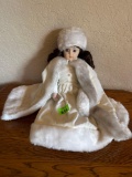 Porcelain doll and white with cape and hat