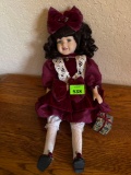 Porcelain doll and maroon dress with present