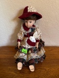 Porcelain doll with hat and rabbit and a pouch