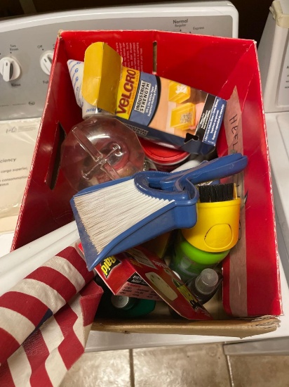 Box of misc items, hummingbird feeder, American flag, Velcro hanging strips, gorilla glue, raid bug