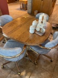 Dining room table with 4 rolling chairs and leaf. Bring help to load