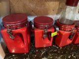 Red glass containers with handles and spoons