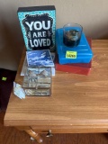 pencil box, glass container, posters, decor, and candle