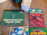 Waste basket, coloring books, construction paper, drawing tablet