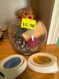 Glass bowl with popery, across, stuffed bear