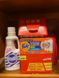 Tide laundry soap, woolite fabric wash, bounce dryer sheets, and tide washer cleaning pouches