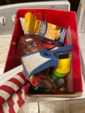 Box of misc items, hummingbird feeder, American flag, Velcro hanging strips, gorilla glue, raid bug