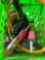Green tote with liquid nails, hammer, flexible gas pipe and more