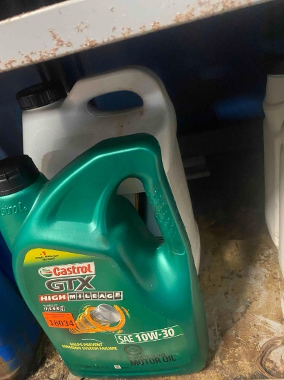 2 bottles of unopened motor oil Contents unknown
