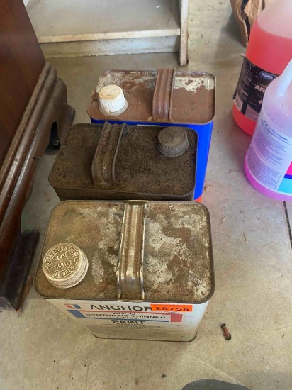 Metal cans labeled denatured alcohol, brake fluid, paint thinner
