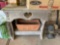 Wooden table and planter, items on top not included. On back porch