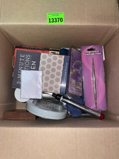 Box with misc items. Nail clippers, cuticle cutters, electronic card games, hearing aid batteries,