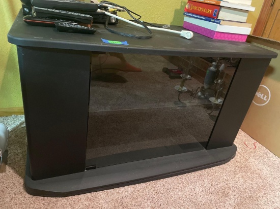 Swiveling tv stand with glass door, see photos for measurements. Contents on top not included, bring