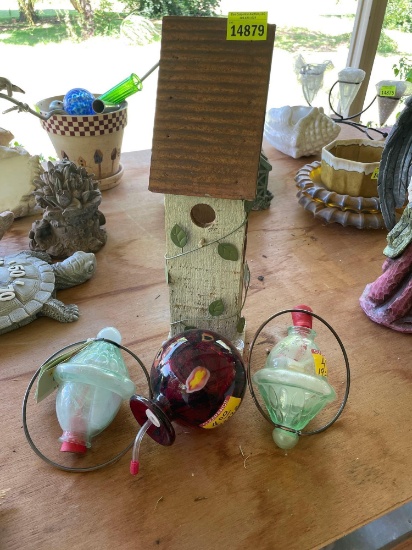 Bird house and hummingbird glass feeders on back porch