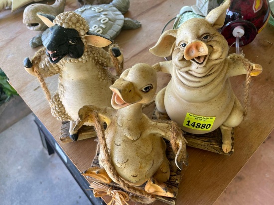 Pig, duck, and sheep swinging decor on back porch