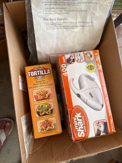 Box with Apple peeler slicer, mini shark, vacuum cleaner, tortilla pan set, and more