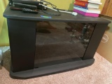 Swiveling tv stand with glass door, see photos for measurements. Contents on top not included, bring