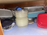 bottom shelf with plastic containers and other kitchen items
