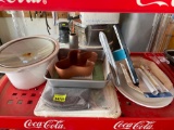 Crock pot dish, cake pan, cactus dish, oven mitts, cutting boards, squigee spray bottle, platter and