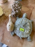 Turtle clock, frog sprinkler, and whale decor on back porch