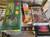 Hummingbird feeder, furniture feet, patio lights, ant bait, and solar panel on shelf on back porch