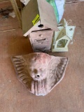 Birdhouse, candle lantern, and angel decor on back porch